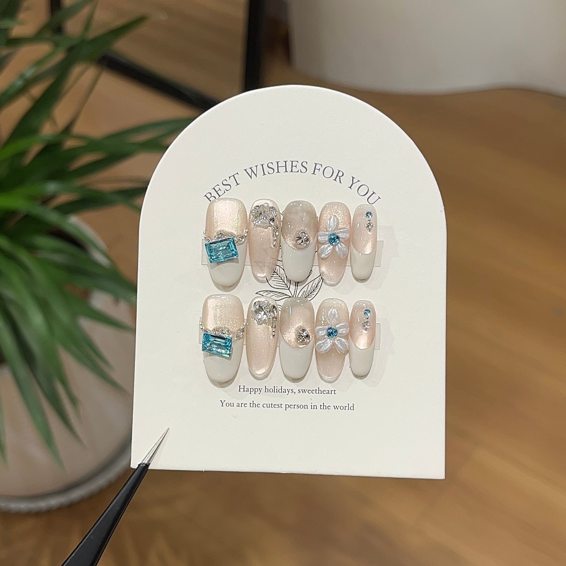 Ivory sapphire press-on nails with soft ivory tones and blue gemstone details