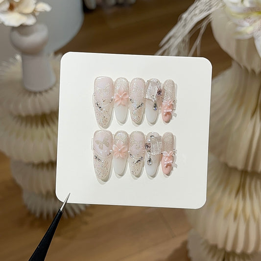 Peach mist press-on nails with soft peach tones and delicate details
