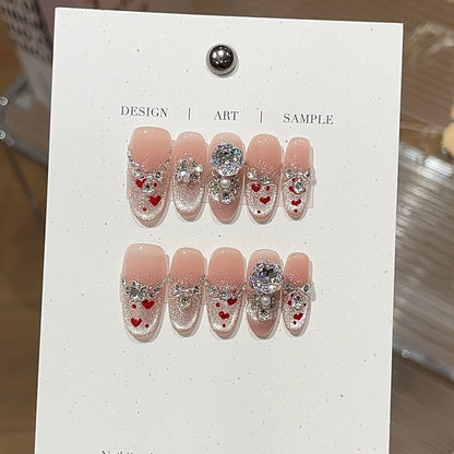 Heart isle press-on nails with romantic heart-inspired details
