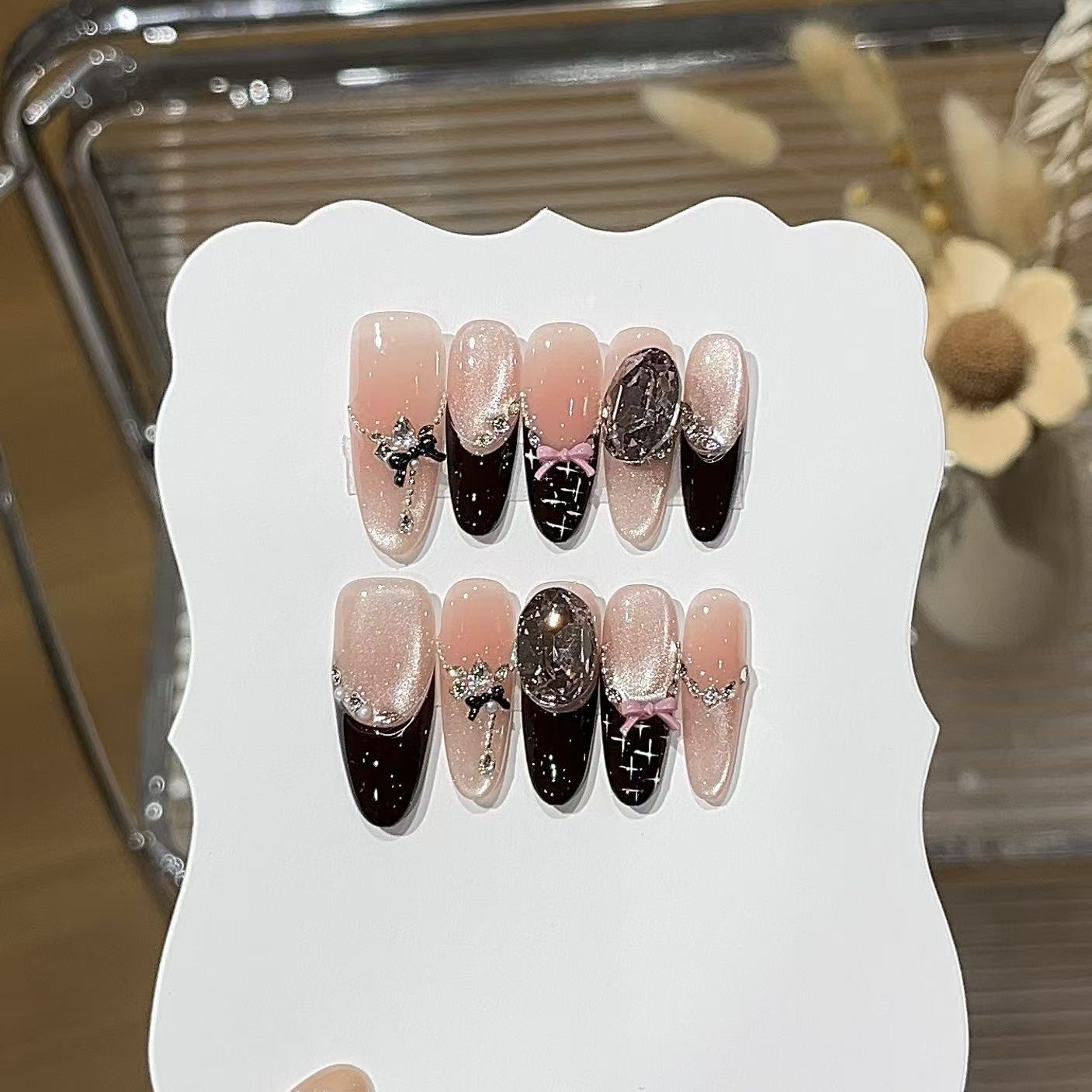 Black pink press-on nails with bold contrast and stylish nail art
